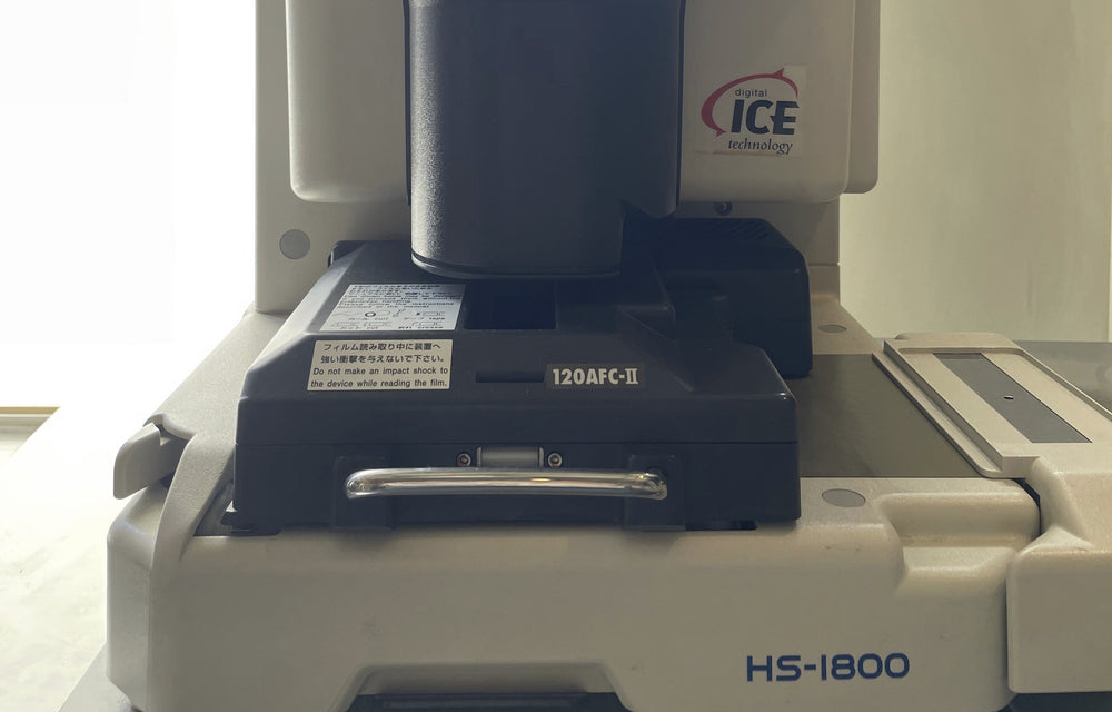 The lab’s Noritsu HS-1800 scanner with its 120 film carrier.