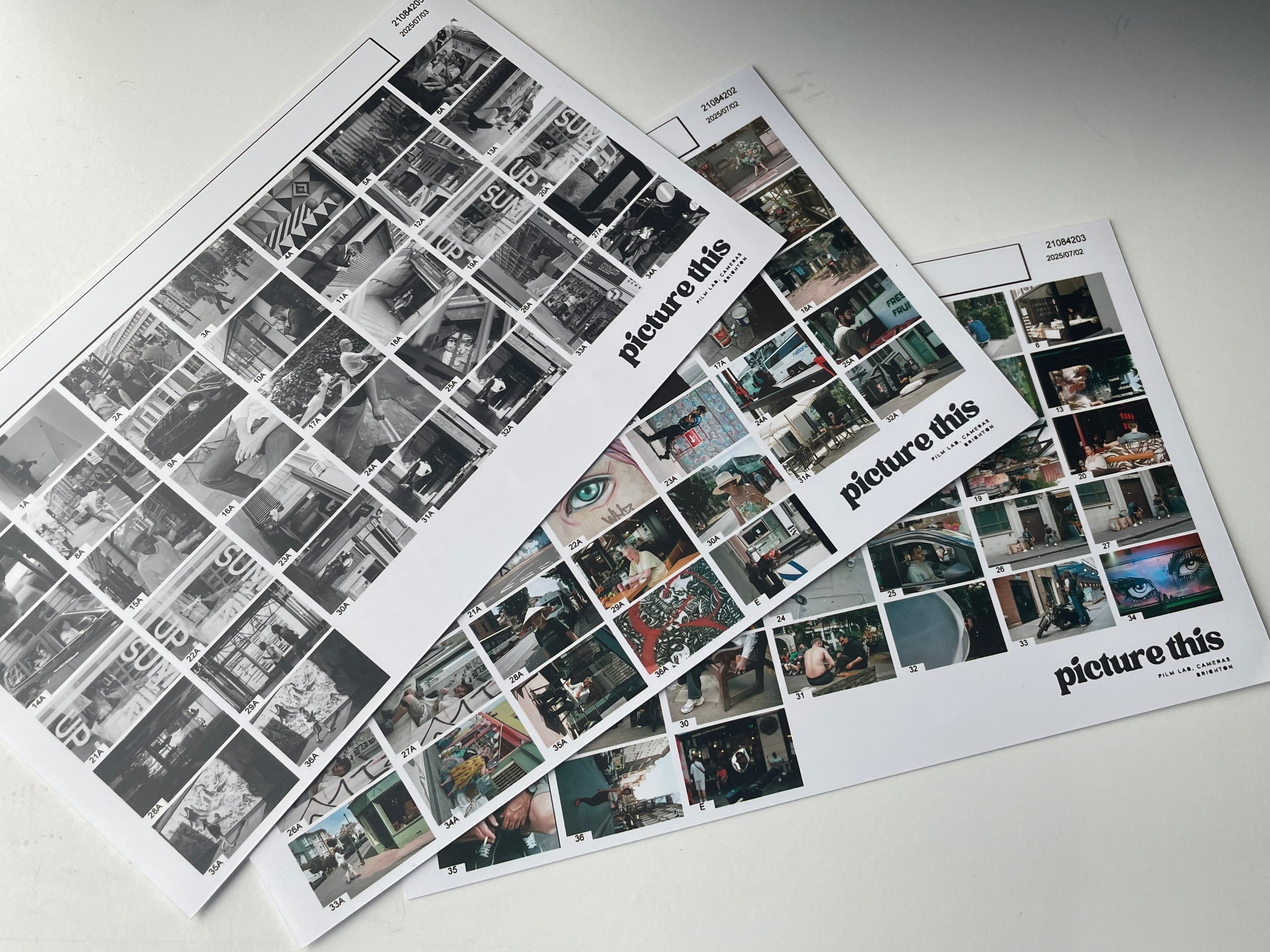 Three sheets of 'picture this' photo index prints on a white surface